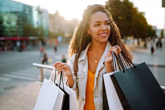 Woman Smiling while Carrying Shopping Bags