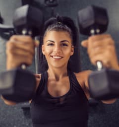 Woman Lifting Weights in Gym