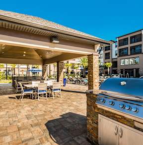 a patio with tables and chairs and a pool
