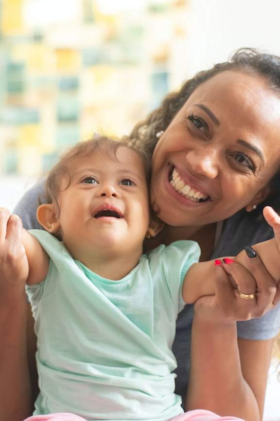 Woman with curly hair is hugging a child at Club Villas Apartments, Georgia, 31047