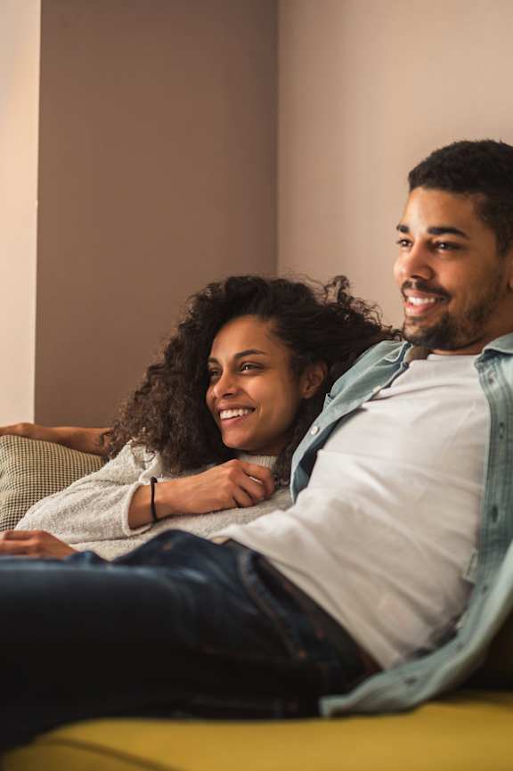 Man and Woman Laying on Couch Together