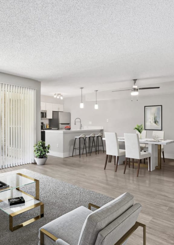 the living room of an apartment with a couch and chairs