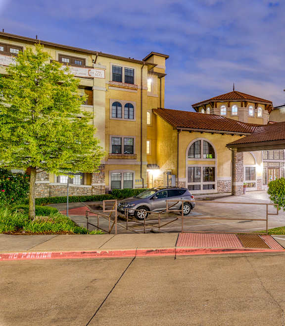 A building with a parking lot in front of it.
