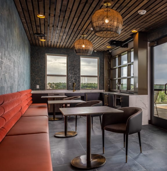 a restaurant with tables and chairs and large windows