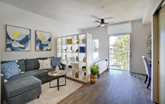 a living room with a couch and a ceiling fan  at The Hub, Washington, 98503