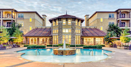 A large house with a pool in front.