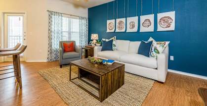 a living room with a white couch and a blue accent wall