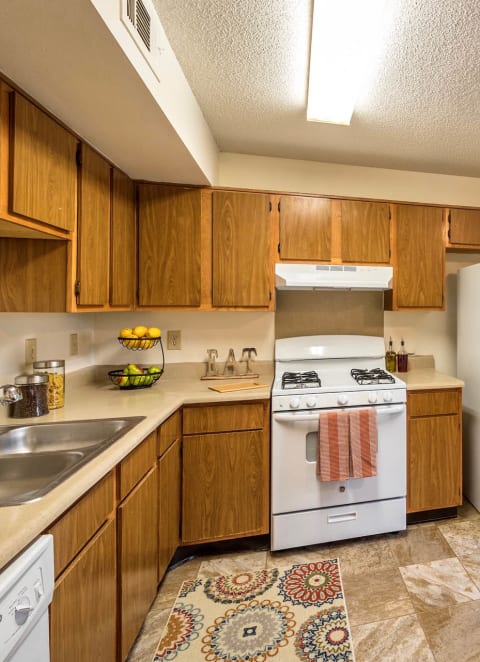 a kitchen with white appliances and wooden cabinets at Olive Branch Townhomes, Batavia, 45103