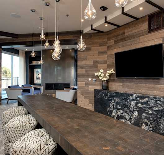 the lobby of a hotel with a bar and a tv
