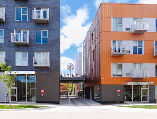 Two modern apartment buildings with balconies and doors.