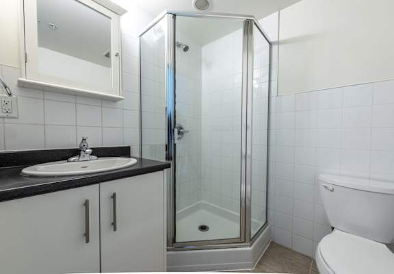 a bathroom with a toilet sink and shower