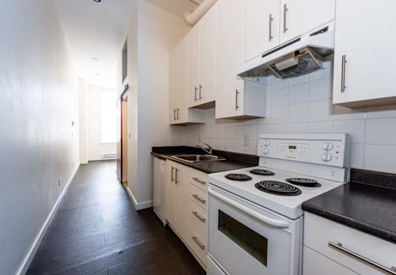 a kitchen with white appliances and white cabinets