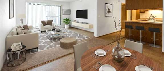 A modern living room with a dining table set for two.