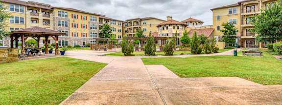 A large building complex with a walkway in the foreground.