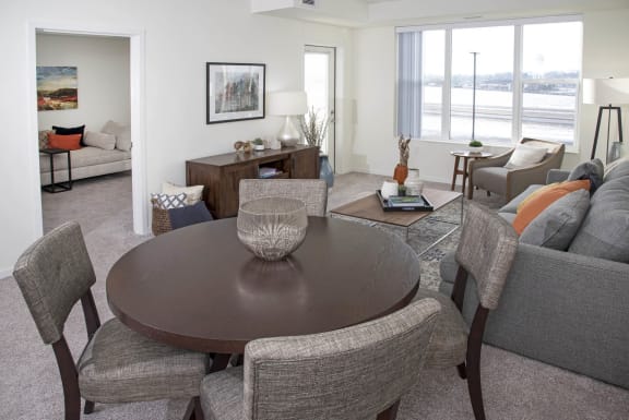 a living room with a couch and a table at The Legends of Cottage Grove 55+ Apartments, Cottage Grove, MN 55016