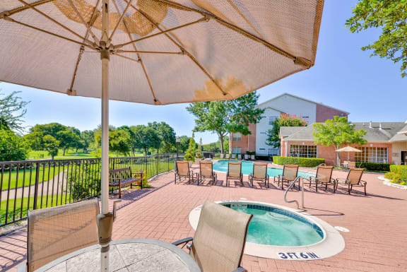 Enjoy a cool swim or warm up in our spa with golf course views at Turnberry Isle Apartments in Dallas, TX offers 1,2 and 3 Bedroom Apartment Homes.
