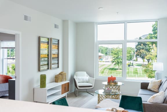 a living room with a couch and a table and a large window