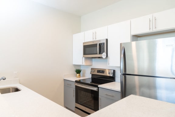 a kitchen with stainless steel appliances and white cabinets