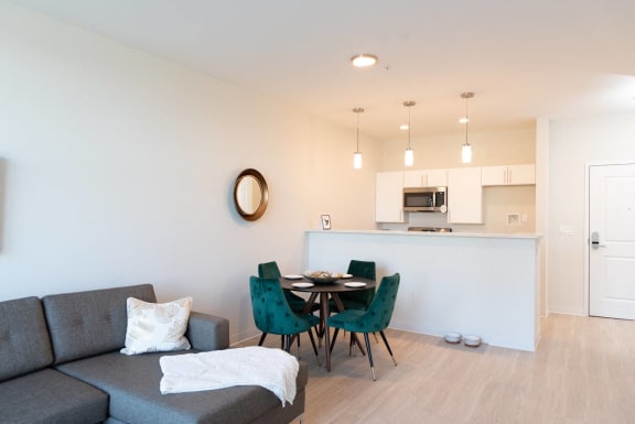 a living room with a couch and a table with chairs
