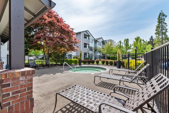 Hanover Apartments Outdoor Hot Tub with Lounge Chairs