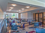 Thumbnail 4 of 5 - a large dining room with tables and chairs and a balcony