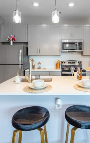 a kitchen with a island with two stools