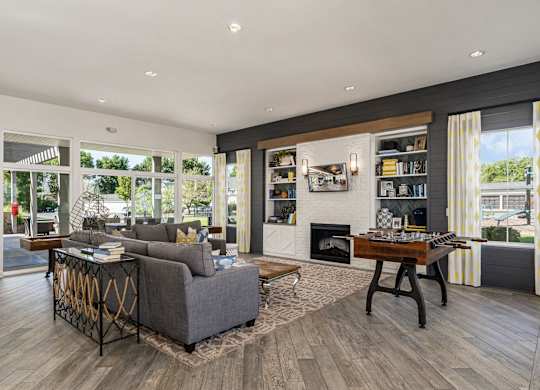 A modern living room with a grey sofa and a wooden coffee table.