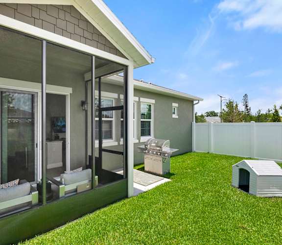 A house with a white fence and a green lawn.