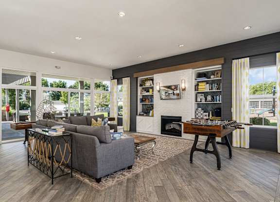 A modern living room with a grey sofa and a wooden coffee table.
