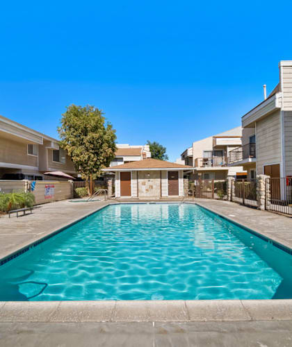 A swimming pool in a residential area surrounded by houses.