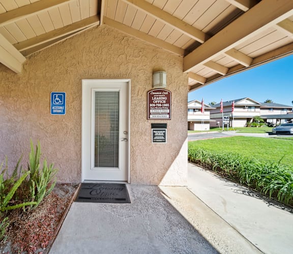 A building entrance with a ramp and a sign indicating it is handicap accessible.