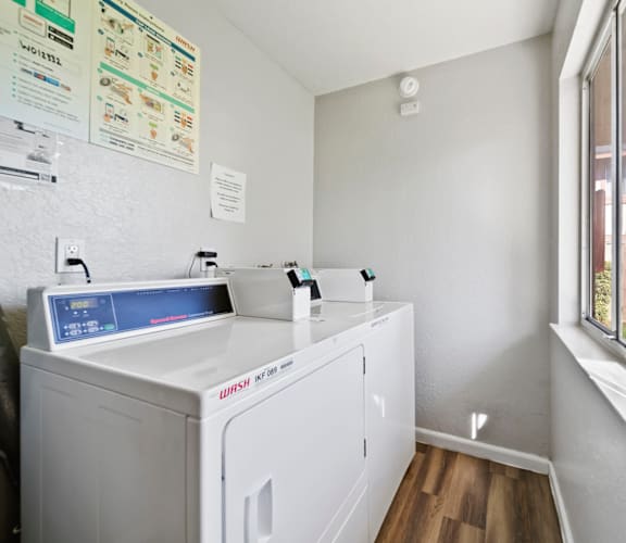 A small laundry room with a washer and dryer.