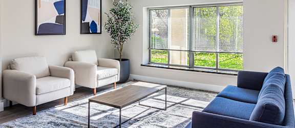 a living room with couches and chairs and a coffee table