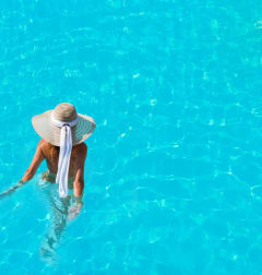 Woman Wearing Hat Walking in Swimming Pool