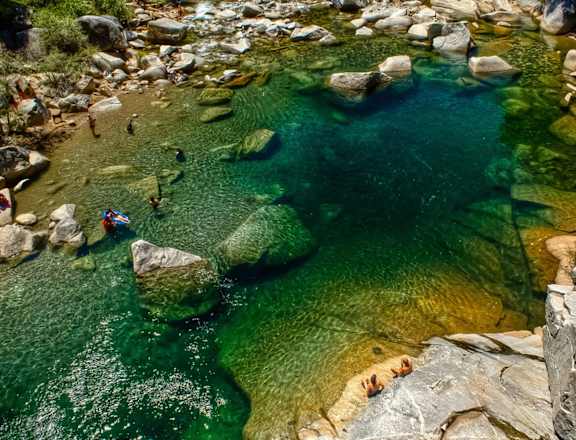 a pool of water with people swimming in it