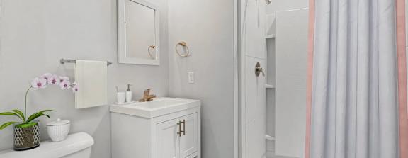 a bedroom with a bed and a ceiling fan at Uphill Flats, Decatur, GA