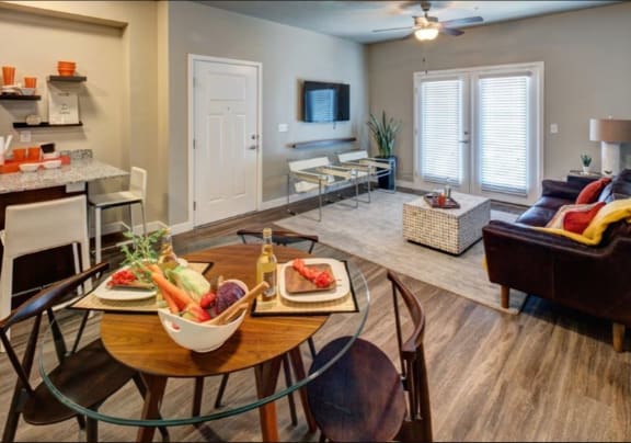 A dining table with chairs and a bowl of fruit on it. at The Alloy at Geneva, Vineyard, UT, 84058