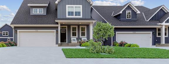 a house with two garage doors and a lawn
