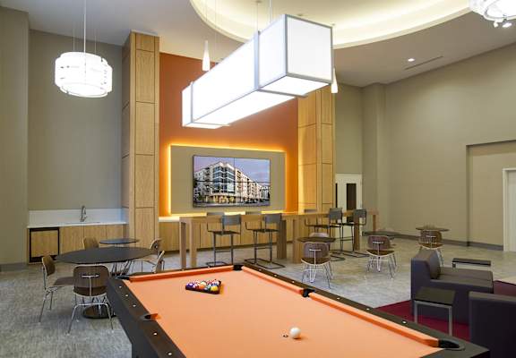 a pool table in a room with tables and chairs