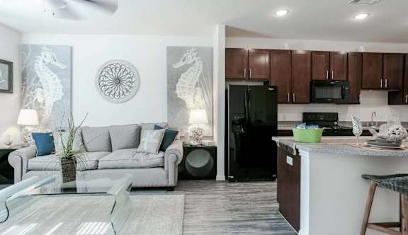 a living room and kitchen with a couch and a table