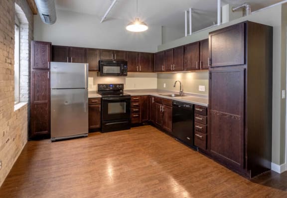 a kitchen with wooden cabinets and stainless steel appliances