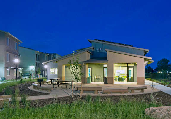 New Harmony Mutual Housing Community community room/office exterior at twilight
