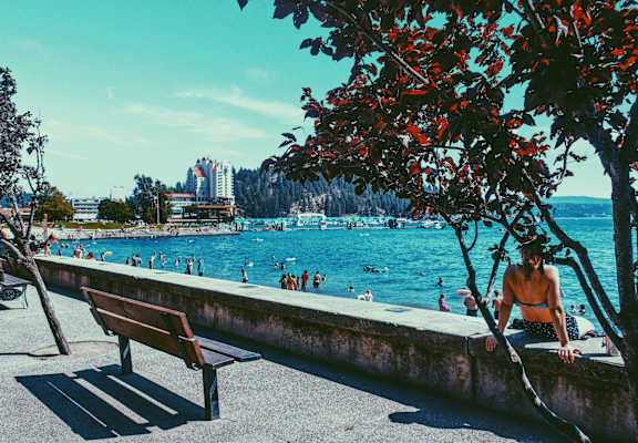 Woman Sitting Down Admiring View of Coeur d'Alene, Idaho Lake