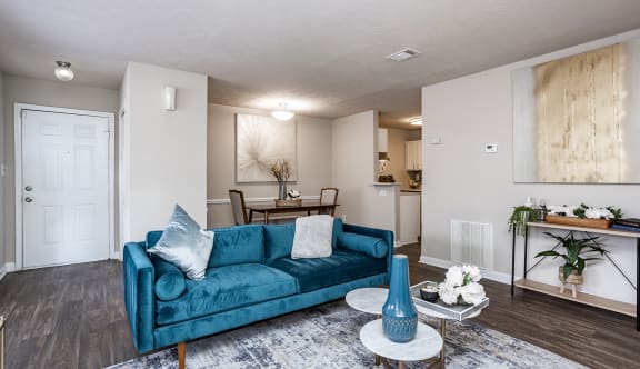 a living room with a blue couch and chair in front of a fireplace