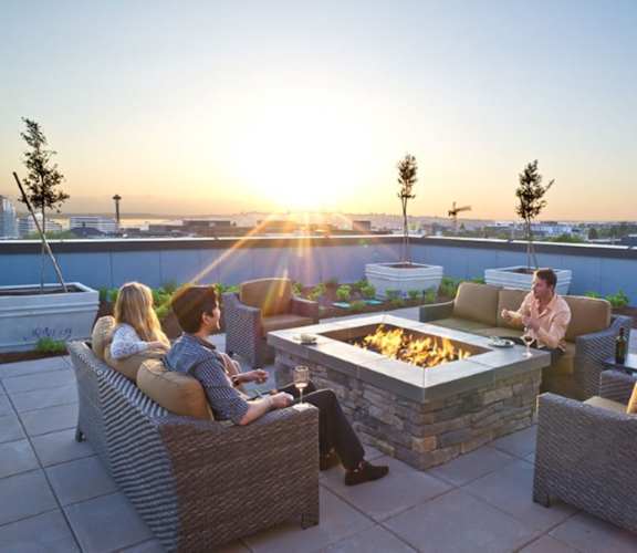 Group of Friends Sitting on Rooftop Patio