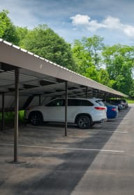 a parking lot with cars parked under awning at North Pointe Commons, Pittsburgh, 15229