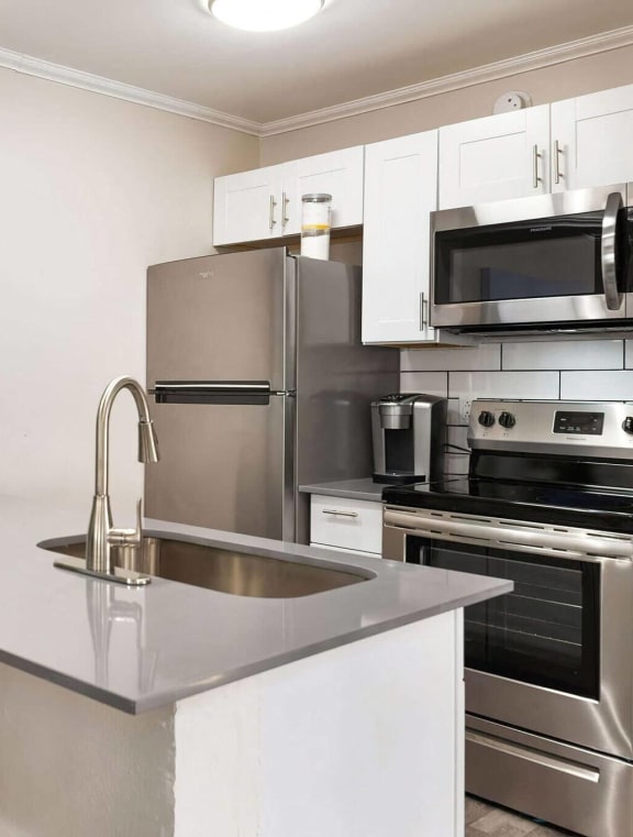 a kitchen with stainless steel appliances and a sink