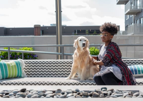 a woman sitting on a bench with a dog