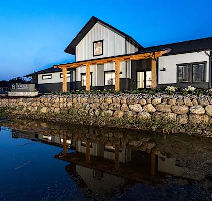 a house reflected in the water at night
