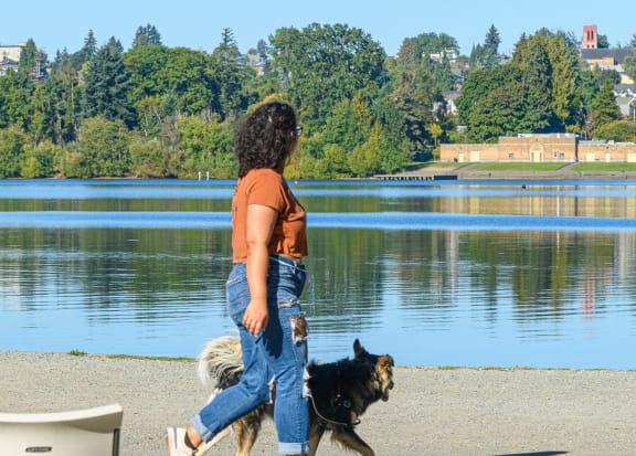 Woman Walking Dog Near Water at Corner 63, Seattle, 98115